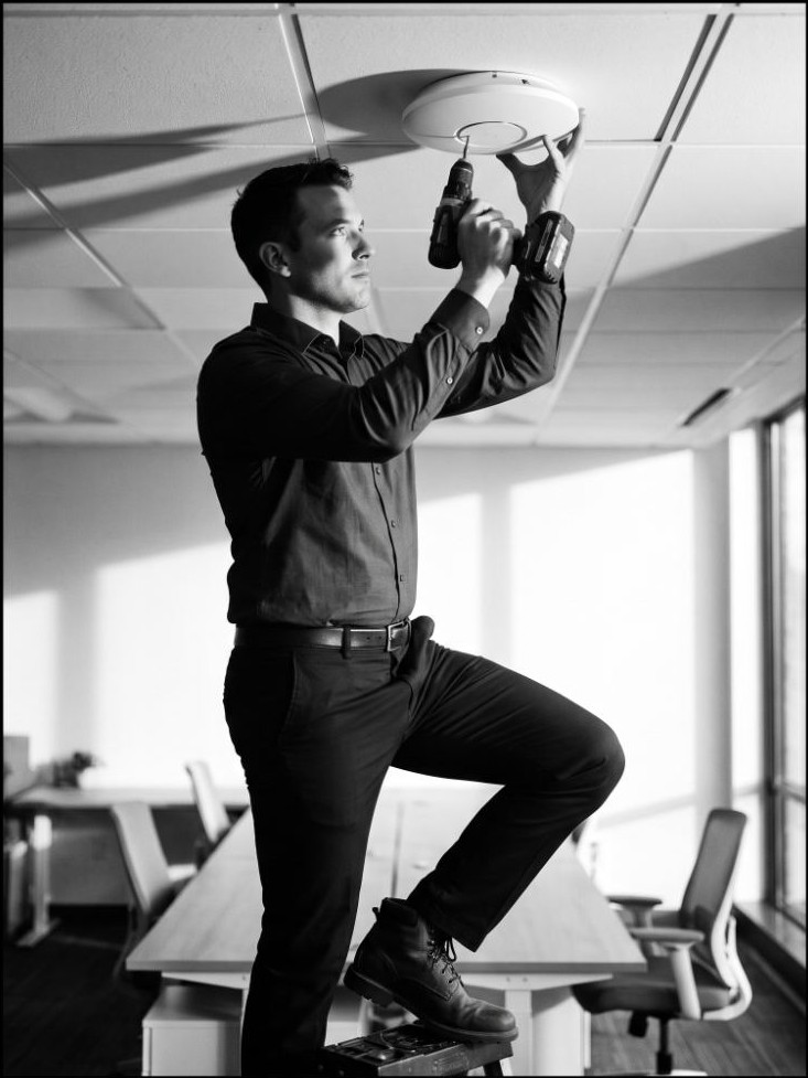 HitechIT technician installing a business-class Wi-Fi access point